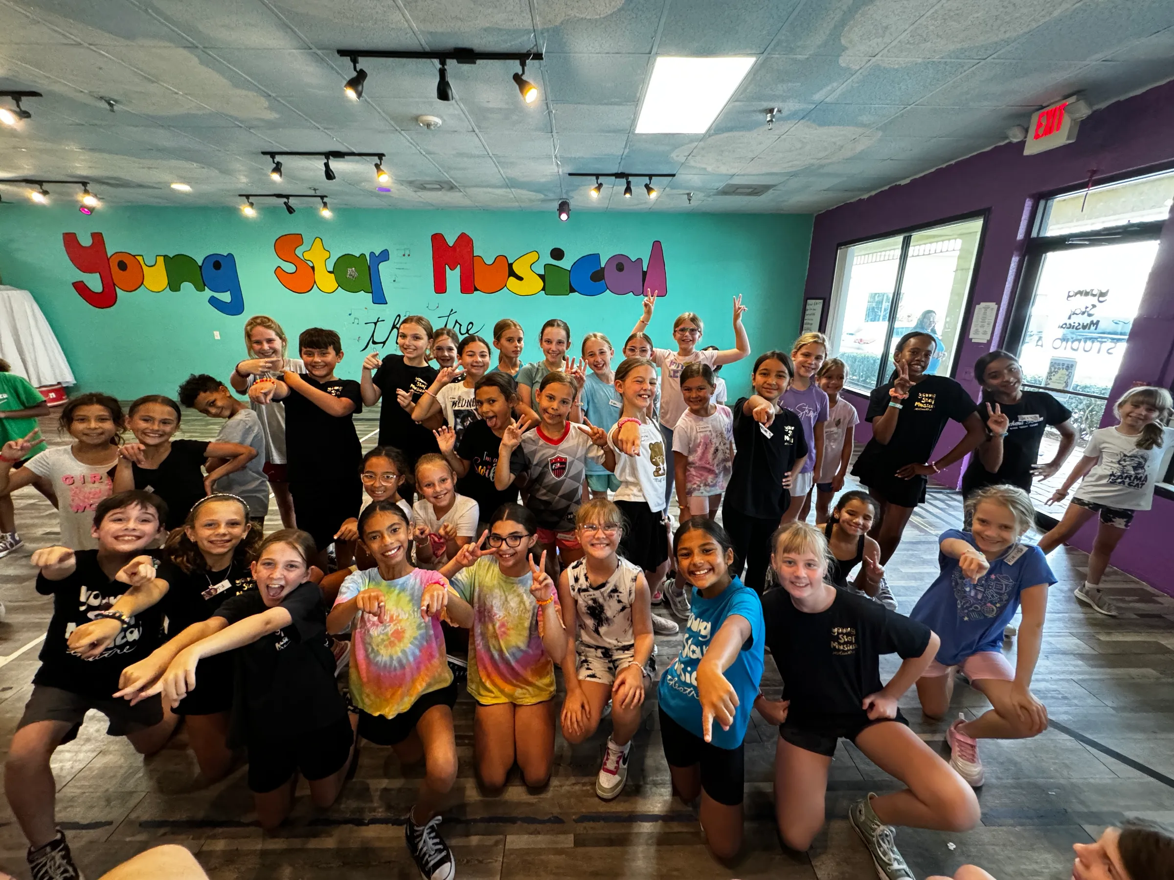 Summer campers on stage at the end of a camp week